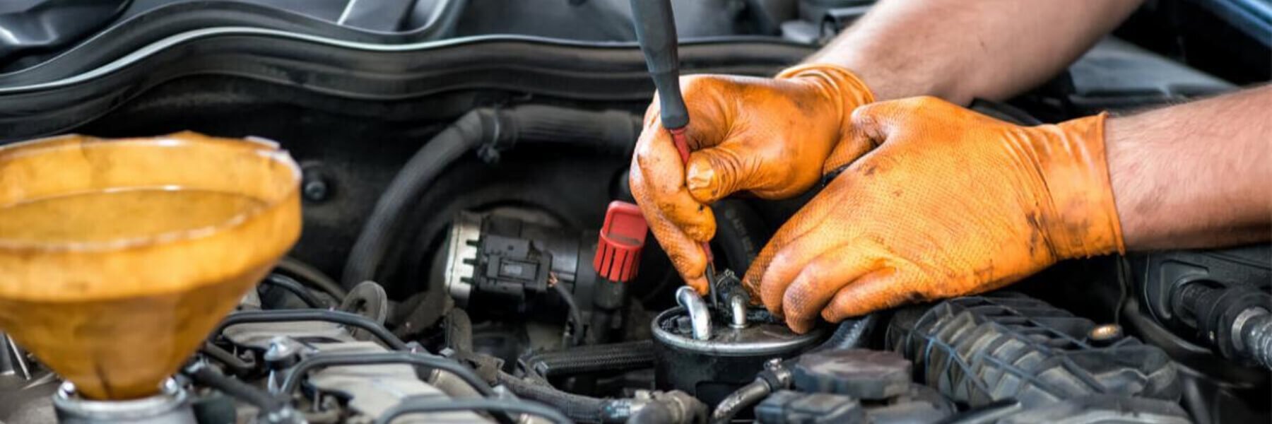 Mechanic working on a diesel filter, close up