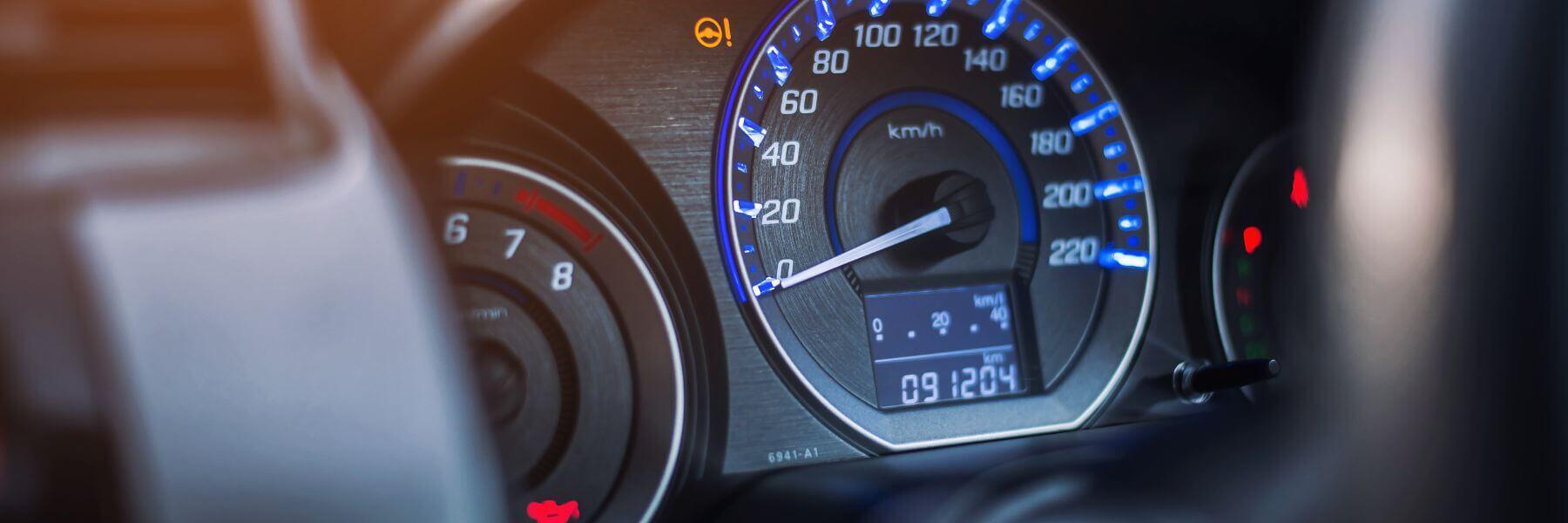 close up of speedometer and odometer with higher mileage