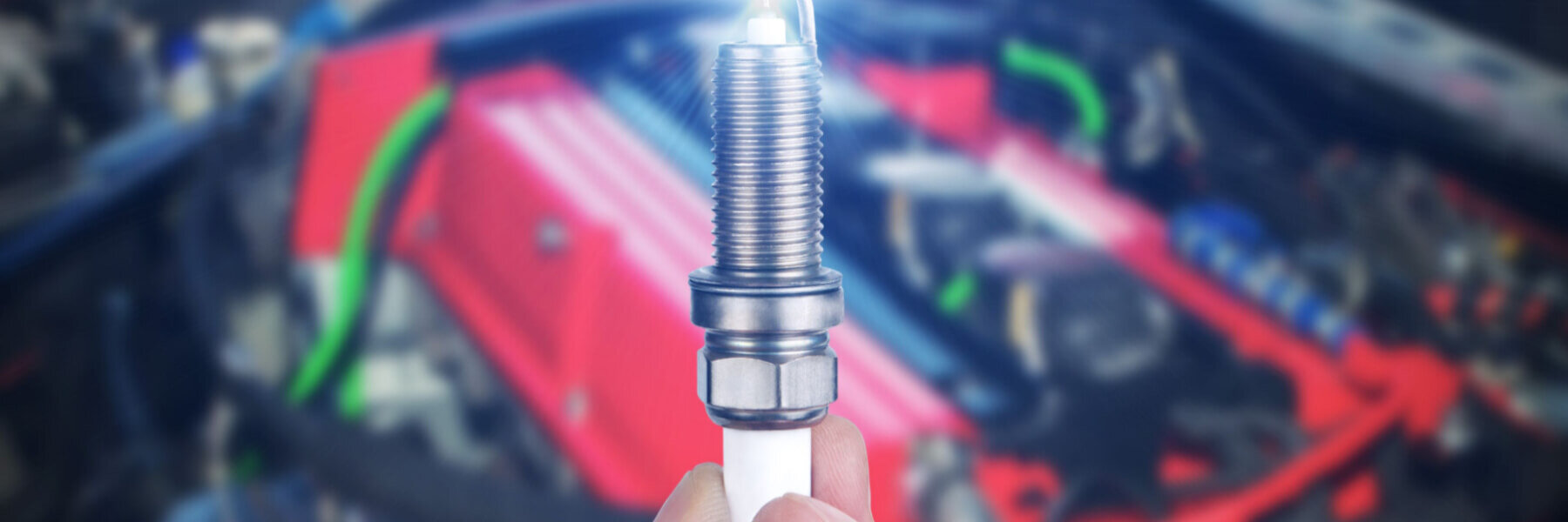 mechanic holding a spark plug