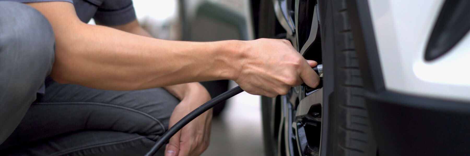 man filling tire with air